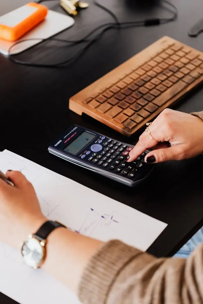 Accountant using calculator.