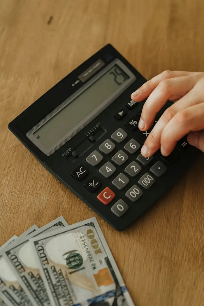 Calculator and one hundred dollar bills.